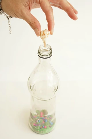 sand and shells in a bottle